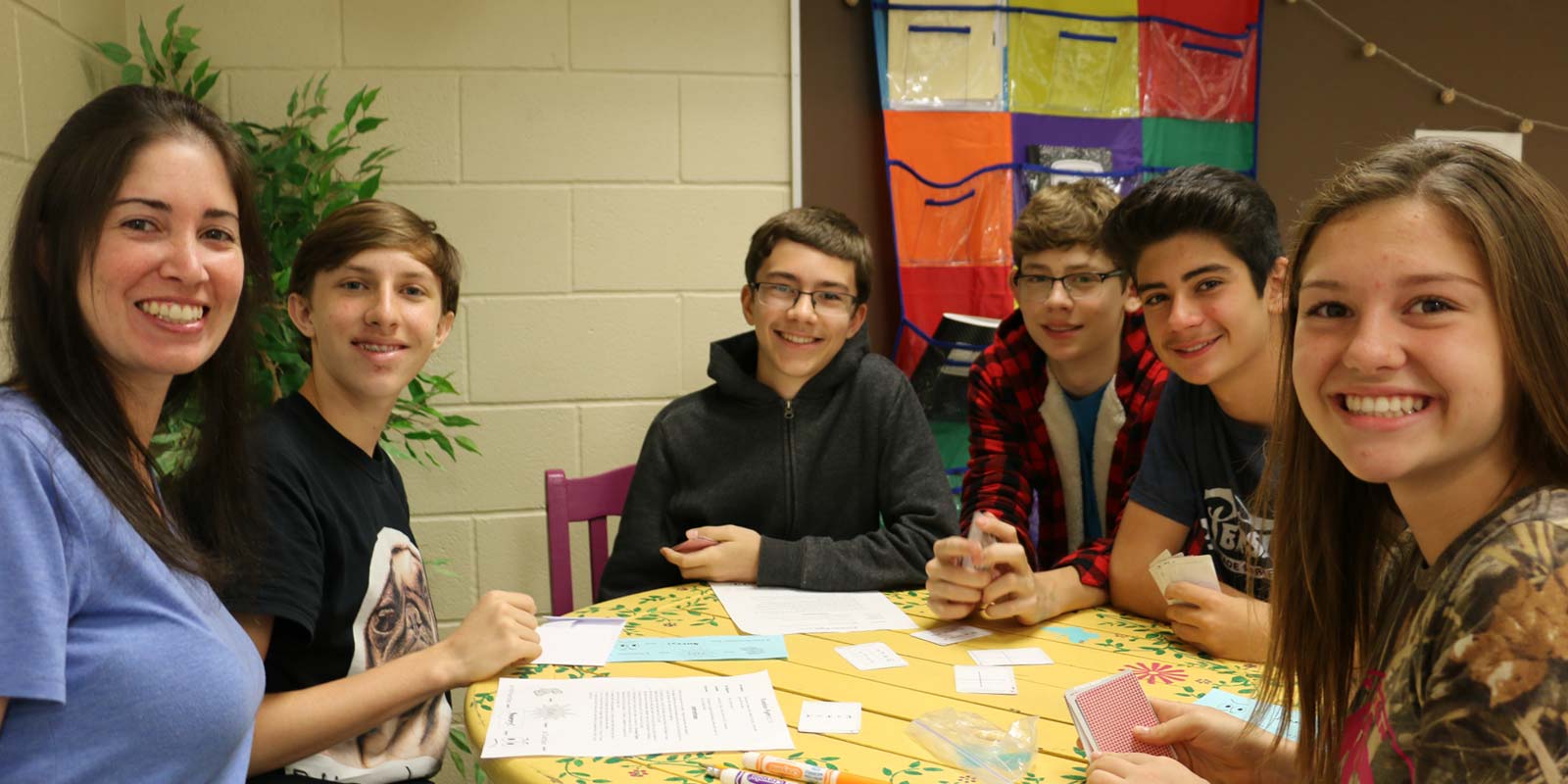 Volunteers coaching a group of students during math class.
